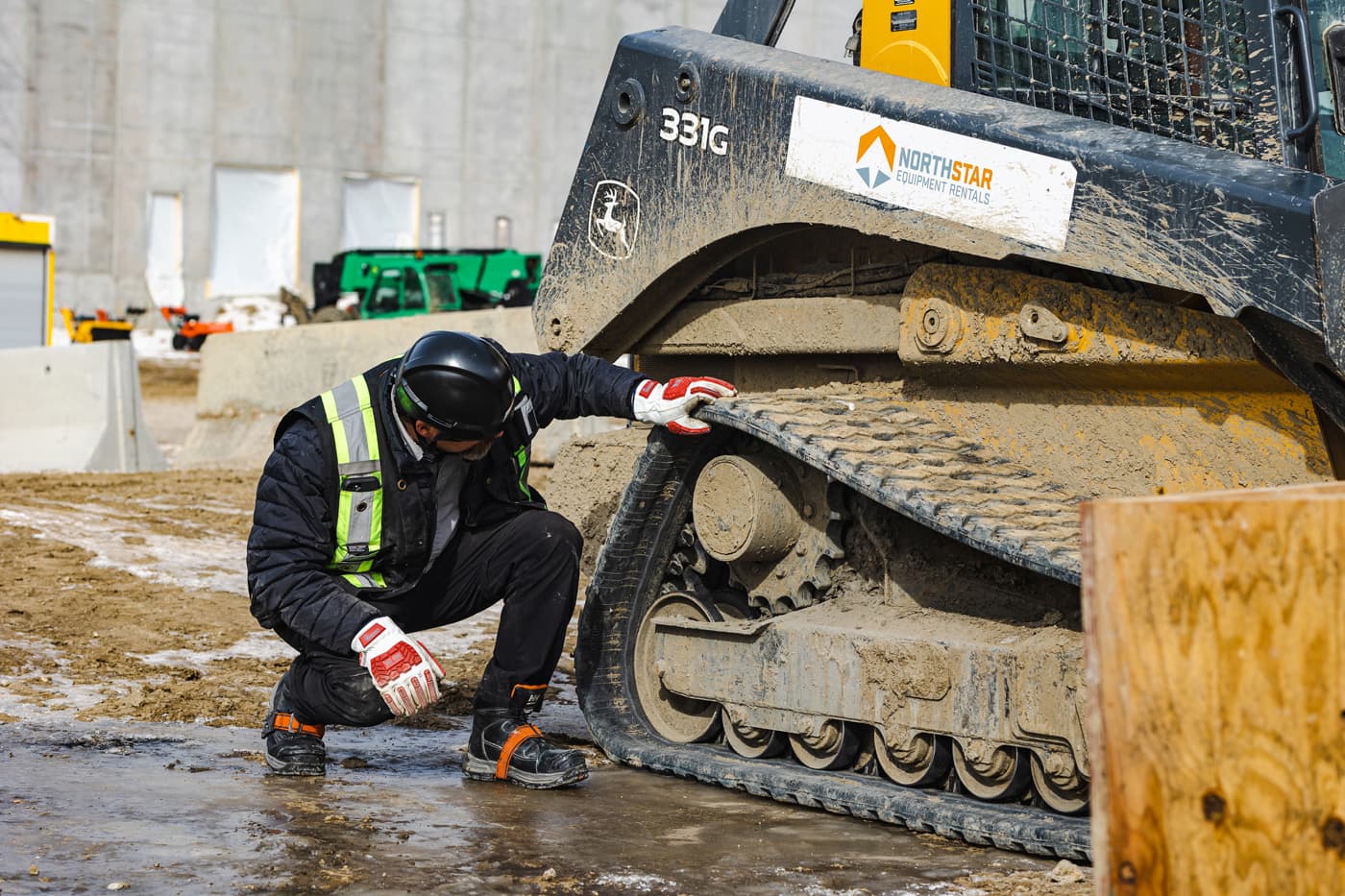 man working on construction equipment